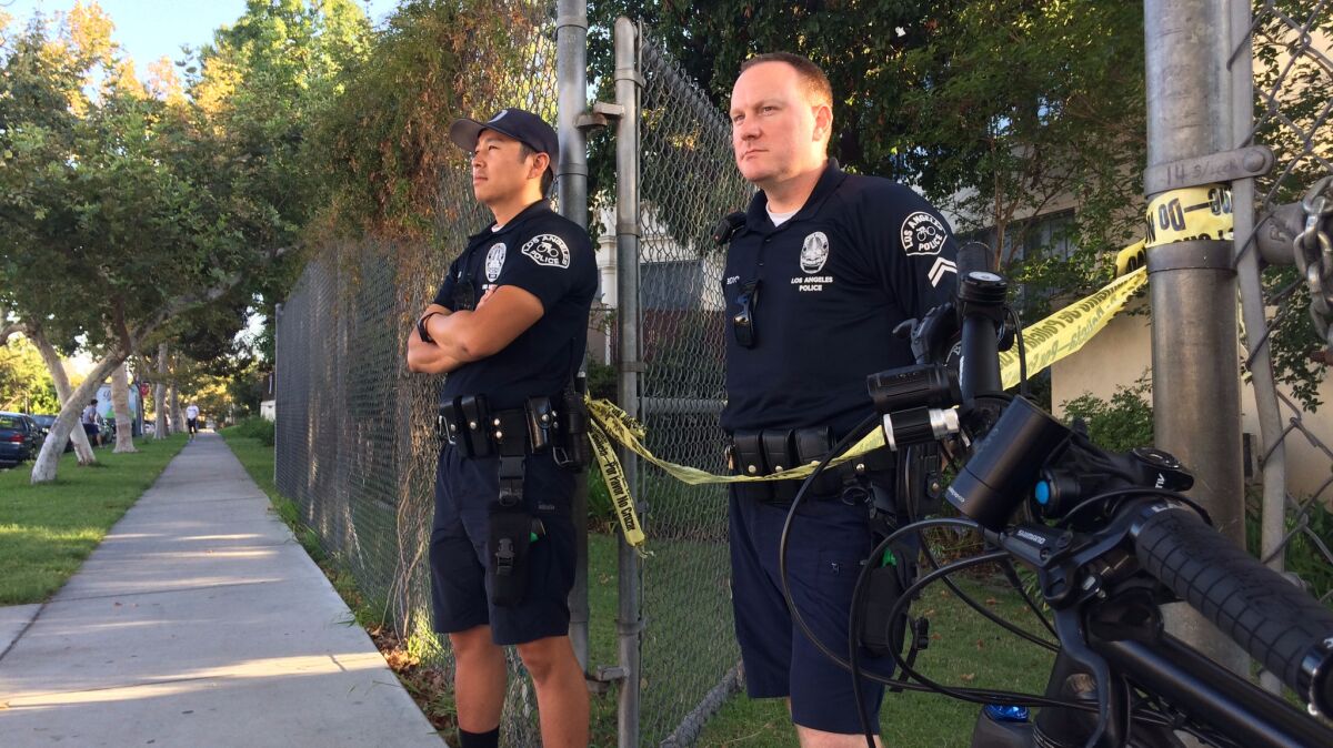 Los Angeles police officers guard an entrance to Van Ness Avenue Elementary School during an investigation of an incident Wednesday on campus.