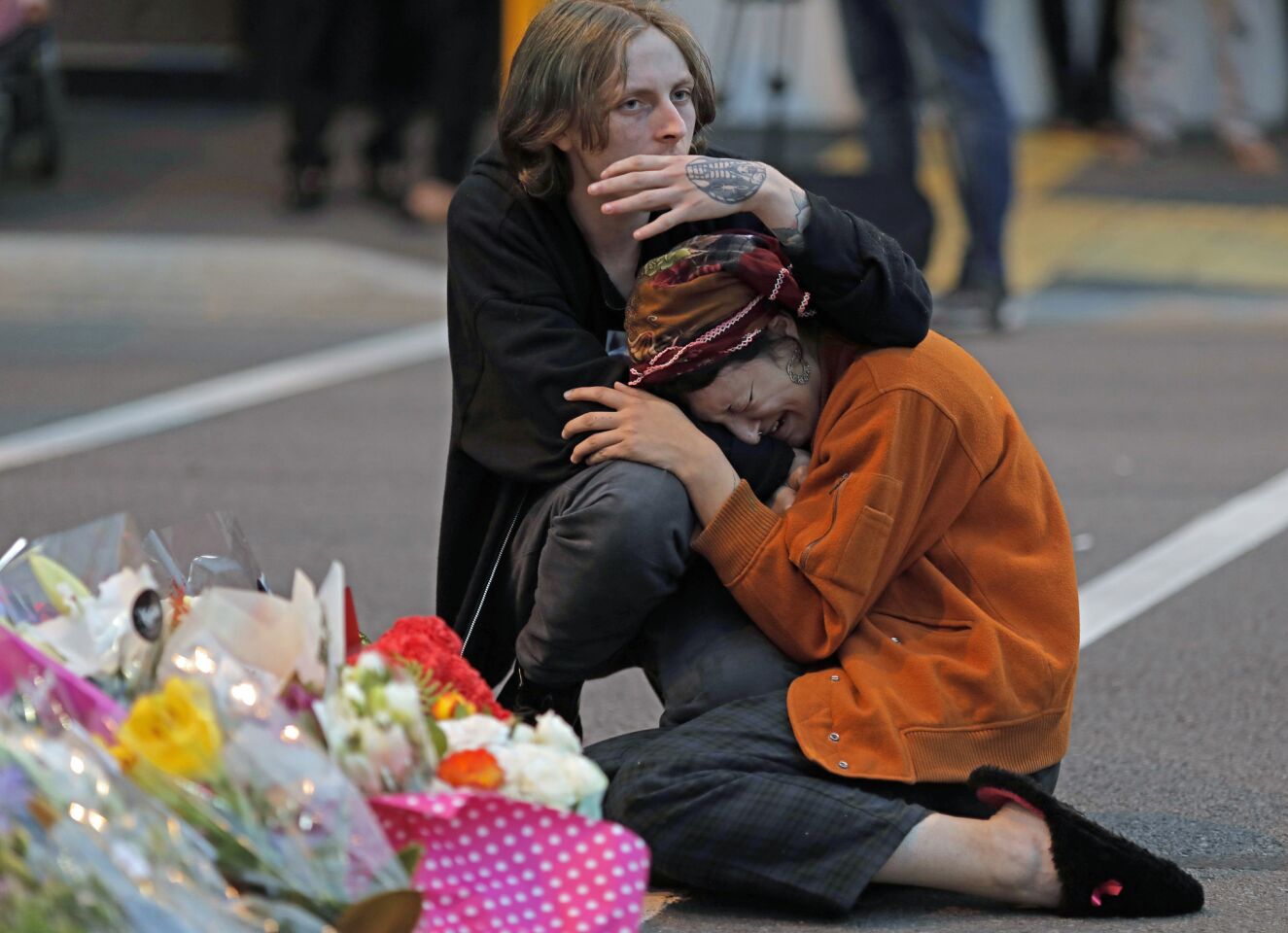 Mourners share their grief at a memorial near the Al Noor Mosque in Christchurch, New Zealand.