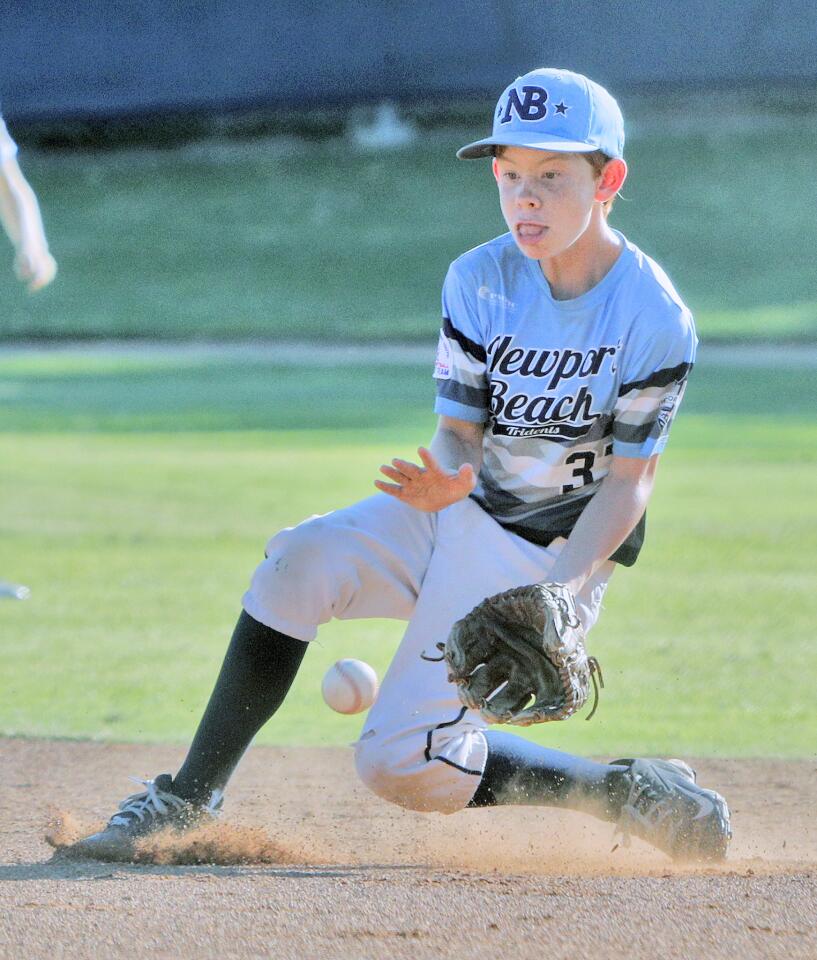 Newport Beach's second baseman Jackson McDonald makes a play on an infield ground ball against Walnut Valley in a PONY Bronco 11-and-under West Zone baseball tournament game at Creekside Park in Walnut on Friday, July 20, 2018.