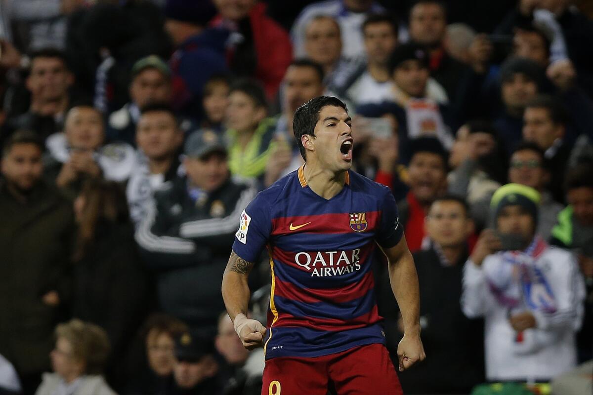 Barcelona's Luis Suarez celebrates after scoring the opening goal during the first meeting of the season between Spanish league rivals Real Madrid and Barcelona. Suarez scored twice in Barcelona's 4-0 win.