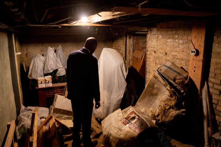 Antioch Mayor Lamar Thorpe looks around the basement at Reign Salon which has a sealed-off spot that once provided Chinese Americans access to the tunnels in late 1870s due to the anti-Chinese sentiment prohibited them from walking through the streets after sunset. Antioch, CA - June 23: on Wednesday, June 23, 2021 in Antioch, CA. (Mengshin Lin / For the Times)