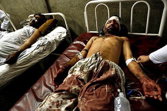Tariq Hussein, a Pearl Continental Hotel driver, lies in the Lady Reading Hospital in Peshawar, Pakistan, where he is being treated for injuries sustained from the bombing at the hotel.