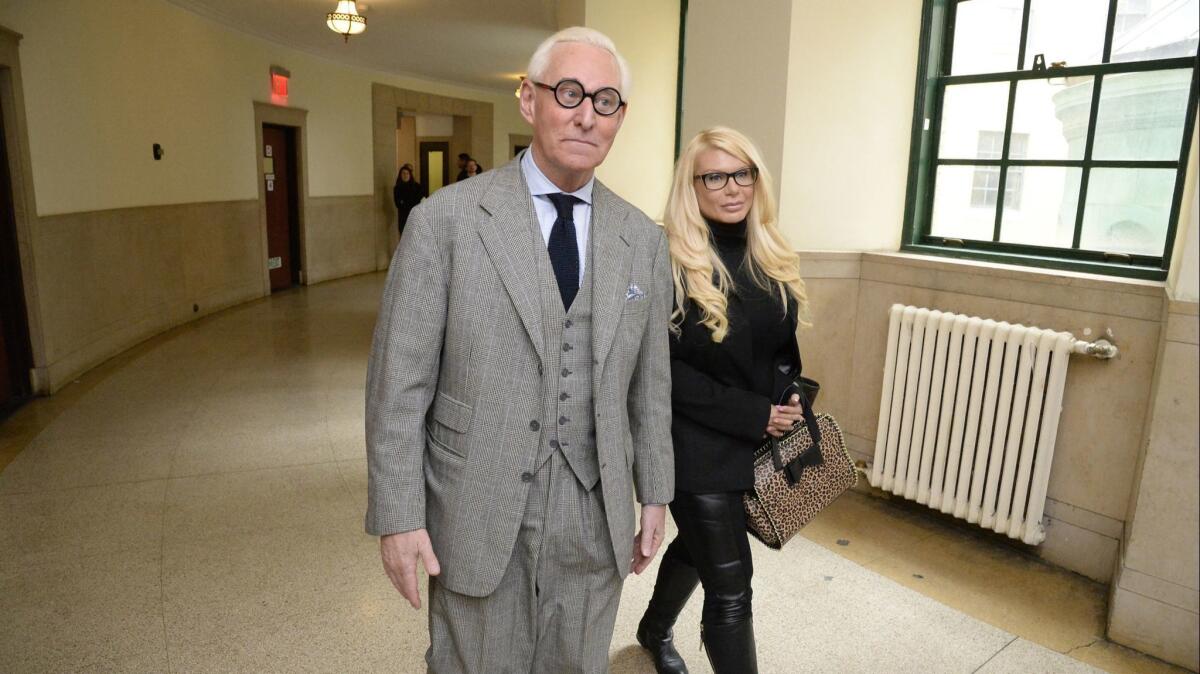 Roger Stone and Kristin Davis, known as the "Manhattan Madam," walk in Manhattan Supreme Court on March 30, 2017.