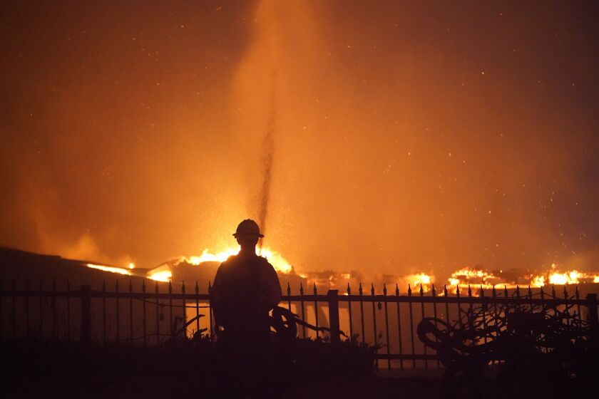 A firefighter helps battle a wildfire in Laguna Niguel, Calif., on Wednesday.