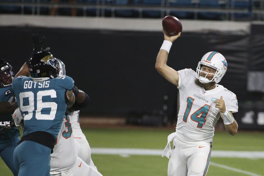 Miami Dolphins quarterback Ryan Fitzpatrick (14) throws a pass against the Jacksonville Jaguars during the first half of an NFL football game, Thursday, Sept. 24, 2020, in Jacksonville, Fla. (AP Photo/Stephen B. Morton)