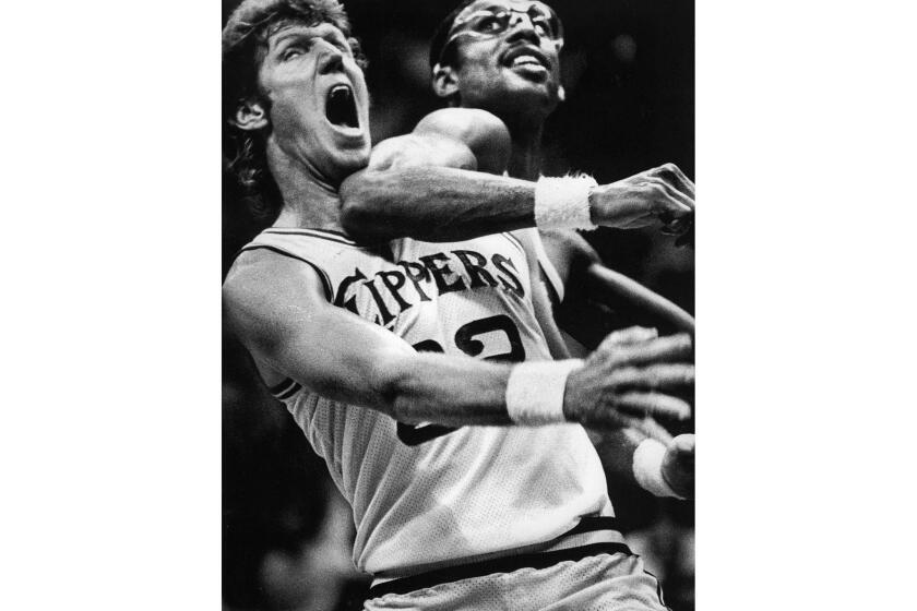 Nov. 2, 1983: Two former UCLA greats, Bill Walton, left, and Kareem Abdul-Jabbar, mix it up under the basket in an NBA game at San Diego. The San Diego Clippers, with Walton, beat the Lakers, led by Abdul-Jabbar, 110-106.