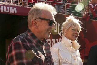 Joe Montana and his wife, Jennifer, arrive before an NFL divisional round playoff football game