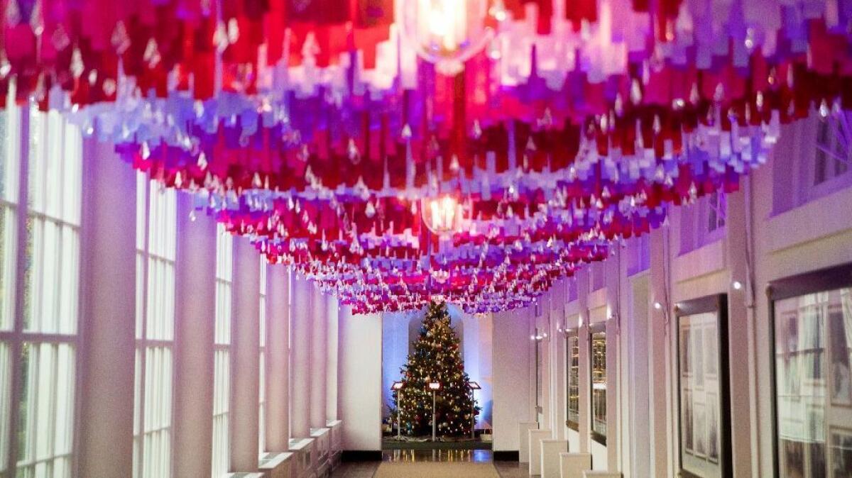 More than 7,500 sparkling crystal ornaments hang from strands of colored ribbons on the East Colonnade of the White House.