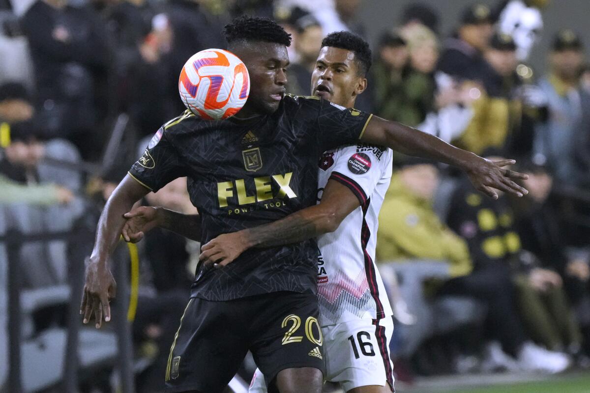 LAFC's José Cifuentes is defended by Alajuelense's Yael Lopez during the second half of a CONCACAF Champions League match.