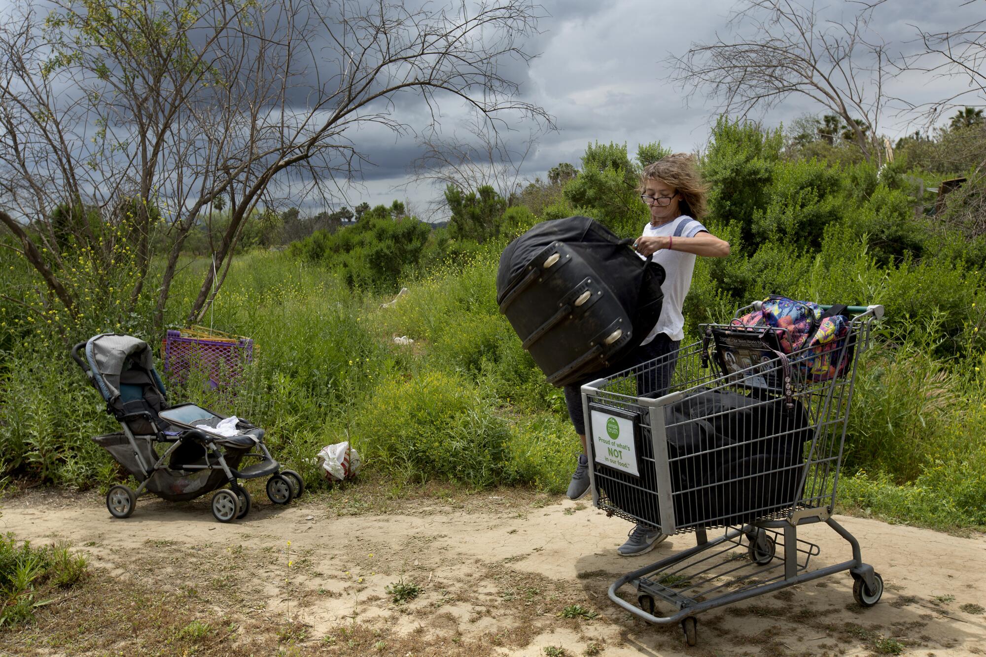 Elizabeth Bolton, 43, known as Alabama, packs her bags to leave a homeless encampment.