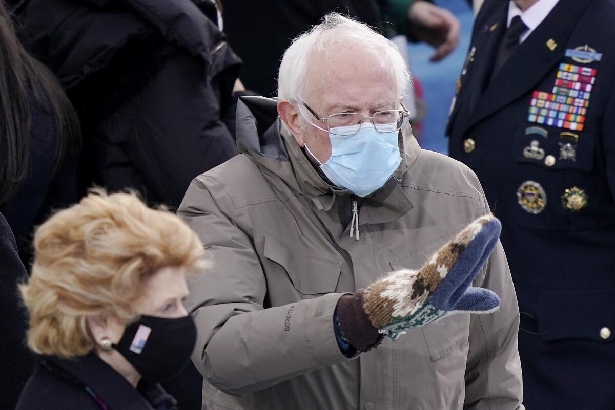 Sen. Bernie Sanders waving in mittens at Wednesday's inauguration