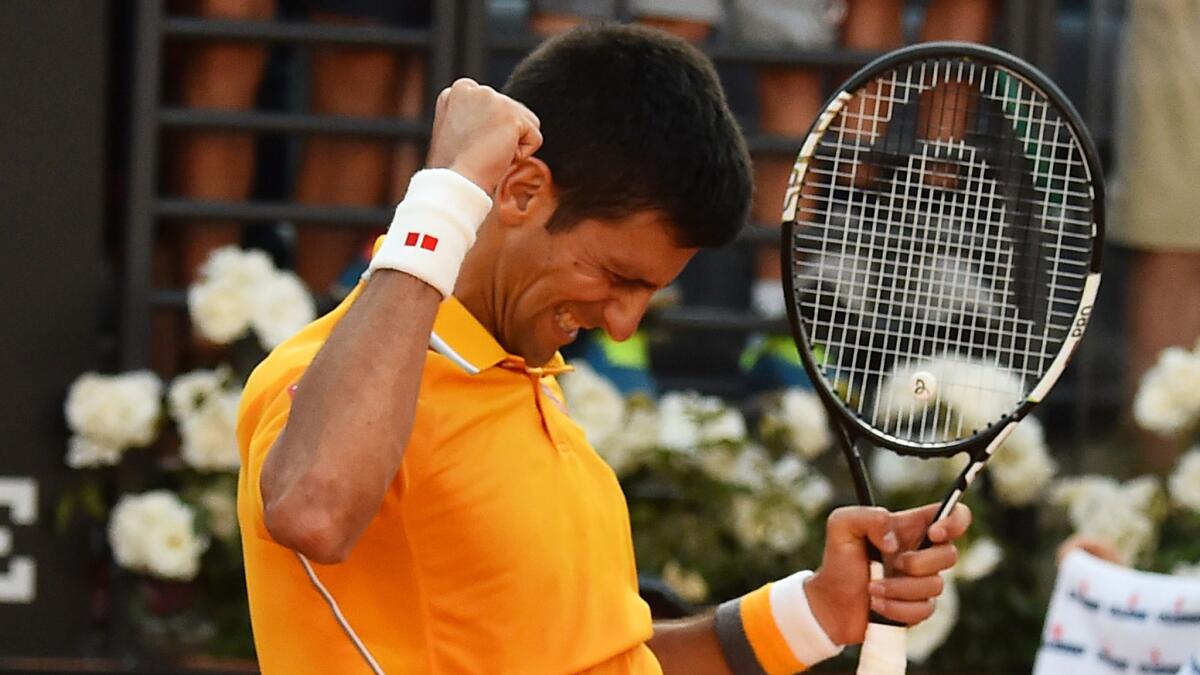 Novak Djokovic celebrates after defeating Roger Federer in the Italian Open final on Sunday.