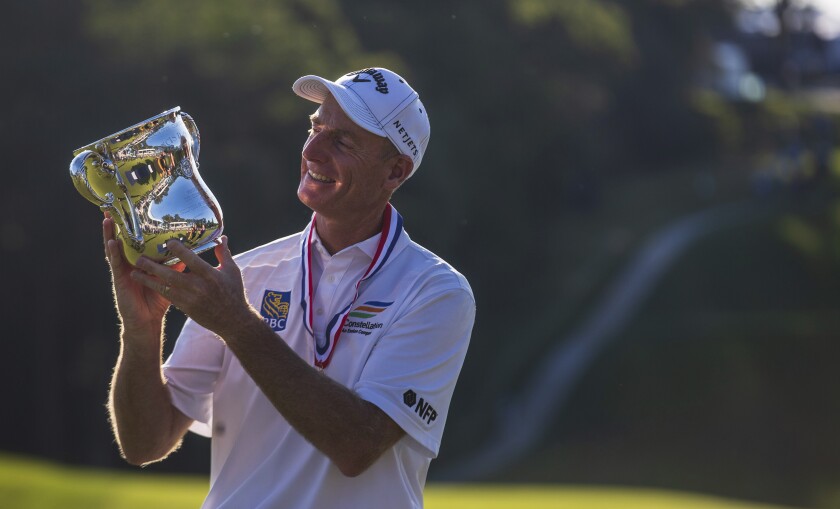 Jim Furyk holds up a trophy after winning the U.S. Senior Open golf tournament at Omaha Country Club on Sunday, July 11, 2021, in Omaha, Neb. (Z Long/The World-Herald via AP)