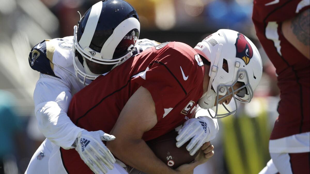 Cardinals quarterback Sam Bradford gets sacked by Rams linebacker Samson Ebukam during a preseason game.