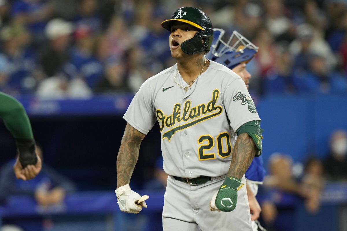 Oakland Athletics' Cristian Pache (20) celebrates after the crossing plate after hitting a two-run home run during ninth-inning baseball game action against the Toronto Blue Jays in Toronto, Saturday, April 16, 2022. (Frank Gunn/The Canadian Press via AP)