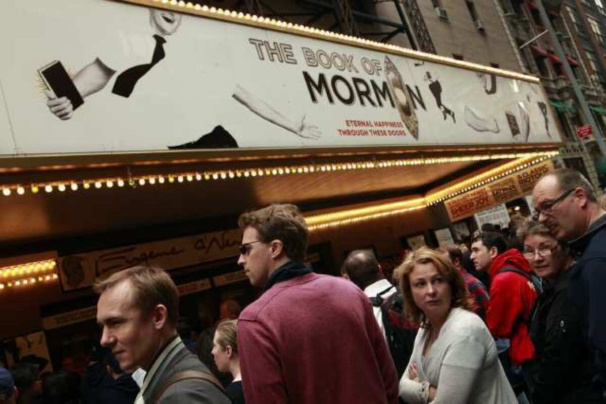 Audiences wait outside the Eugene O'Neill Theatre in New York to see "The Book of Mormon."