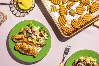 A photograph of Chicken bites and a celery salad served with frozen fries by Dawn Perry for the Los Angeles Times Week of Meals.