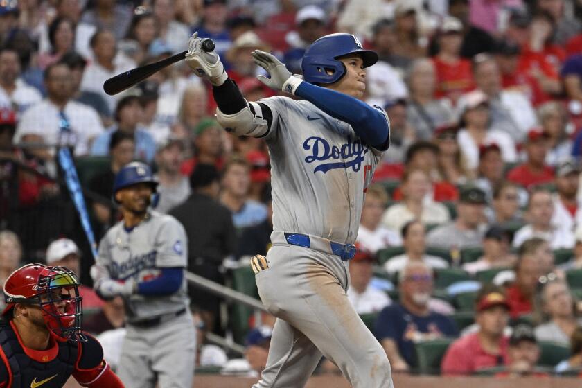 Dodgers star Shohei Ohtani follows through on a home run against the St. Louis Cardinals on Saturday.