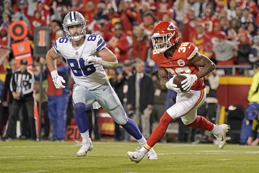 Kansas City Chiefs cornerback L'Jarius Sneed (38) is chased by Dallas Cowboys tight end Dalton Schultz (86) after catching an interception late in the second half of an NFL football game, Sunday, Nov. 21, 2021, in Kansas City, Mo. The Chiefs won 19-9. (AP Photo/Charlie Riedel)