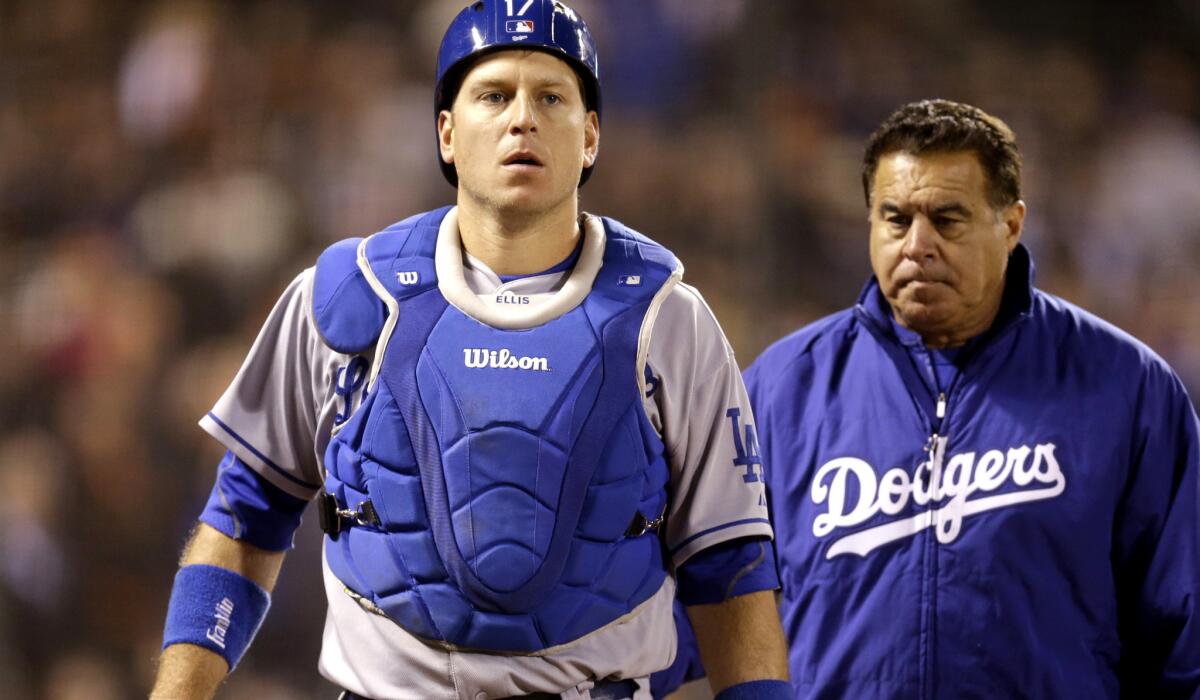 Dodgers catcher A.J. Ellis leaves the field after taking a foul ball off his throwing hand in the ninth inning of an April 22 game against the Giants in San Francisco.