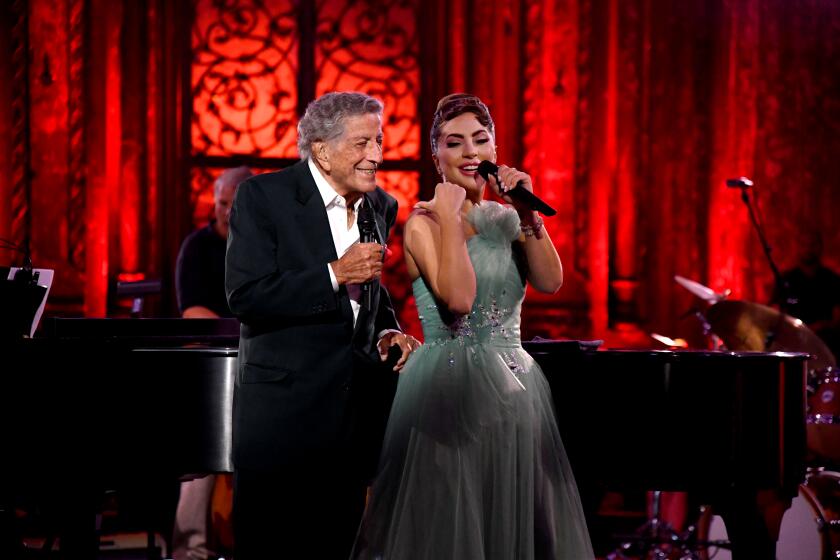 Tony Bennett and Lady Gaga sing onstage together in formalwear
