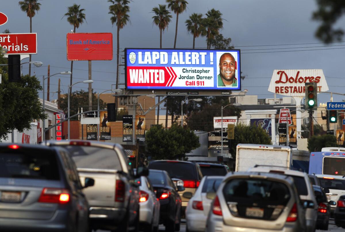 A digital billboard along Santa Monica Boulevard shows a "wanted" alert for former Los Angeles police officer Christopher Dorner.
