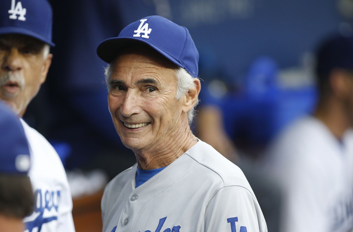 FILE - Los Angeles Dodgers Hall of Fame pitcher Sandy Koufax, on hand for the Dodgers' Old Timers Game festivities, smiles as he talks to current members of the team in the dugout before the baseball game between the Los Angeles Dodgers and Colorado Rockies, Saturday, May 16, 2015, in Los Angeles. On Monday, March 14, 2022, the Los Angeles Dodgers announced that Koufax is joining fellow Hall of Famer Jackie Robinson with a bronze statue of his own at Dodger Stadium, with an unveiling planned for June 18, 2022, before the team hosts Cleveland. (AP Photo/Danny Moloshok, File)
