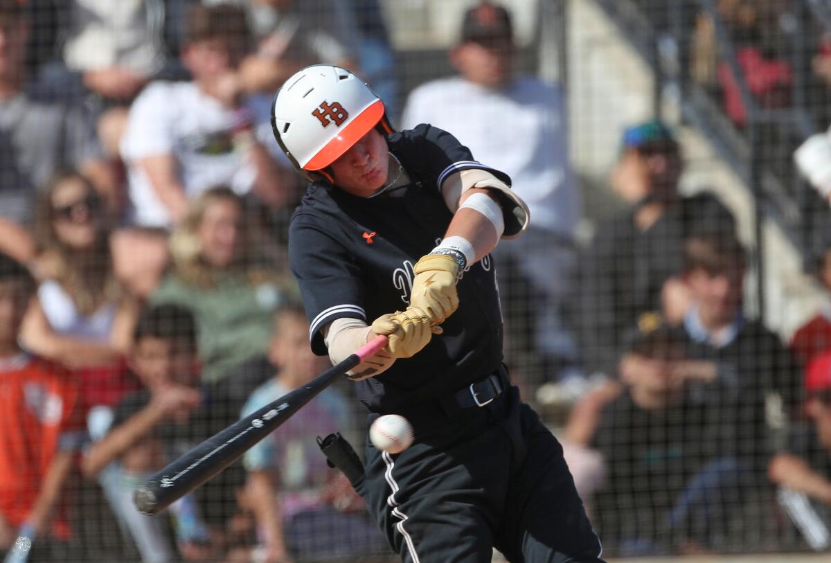 Trent Grindlinger of Huntington Beach belts a double during Tuesday's game against Bishop Amat.