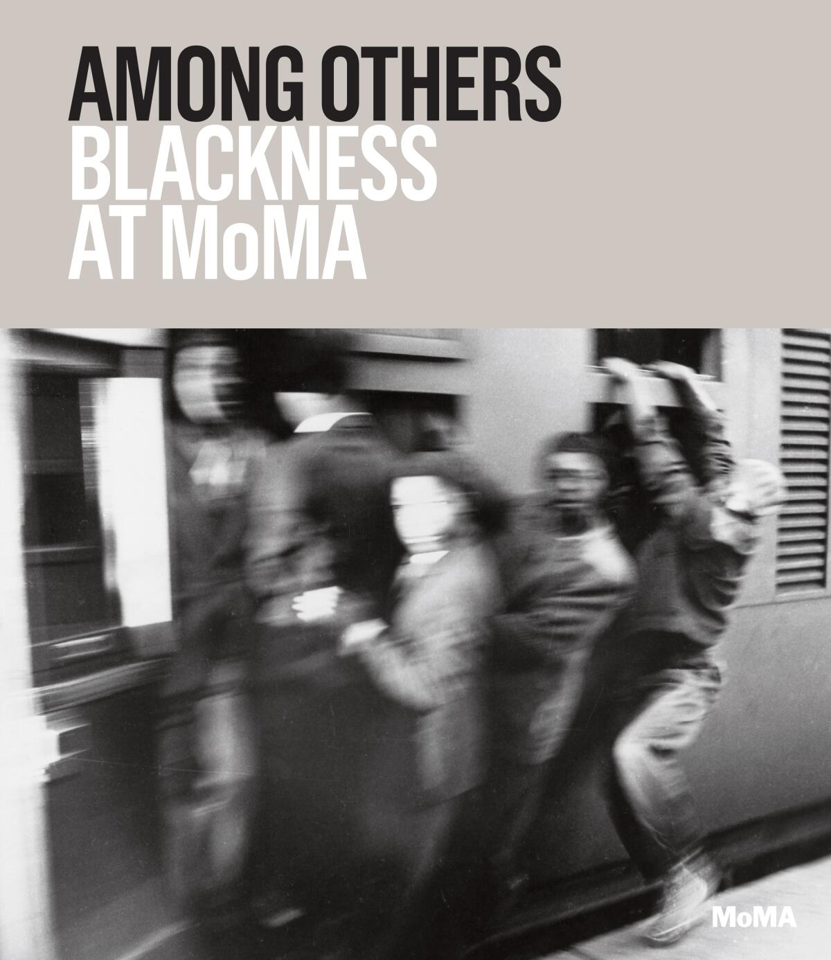 A book cover features a blurry black and white image of men hanging off of a train