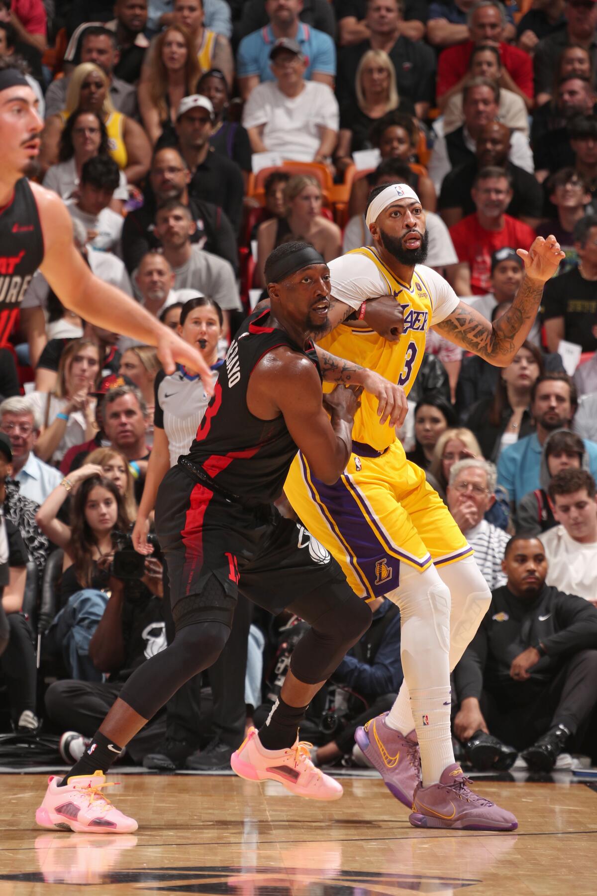 Lakers forward Anthony Davis, right, battles Miami Heat center Bam Adebayo for position.