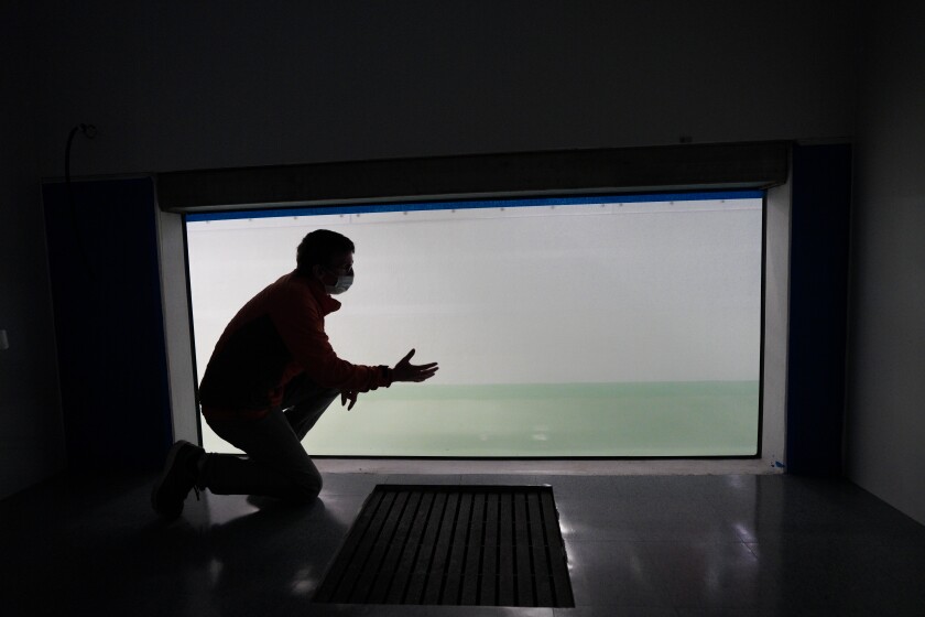 Scripps Institution of Oceanography researcher Dale Stokes in an observation room of the ocean and atmosphere simulator.
