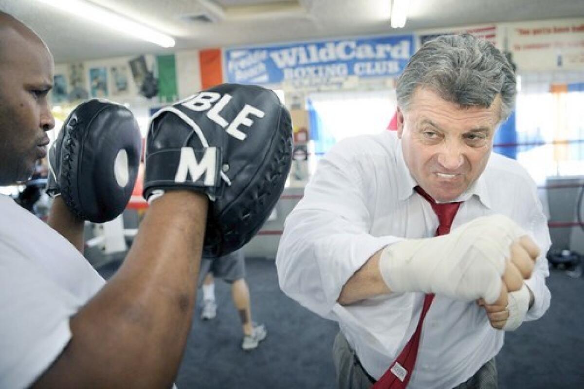 Carmen Trutanich, right, spars with former heavyweight champion Michael Moorer at a boxing club in Hollywood. He faces four rivals in the L.A. city attorney race.