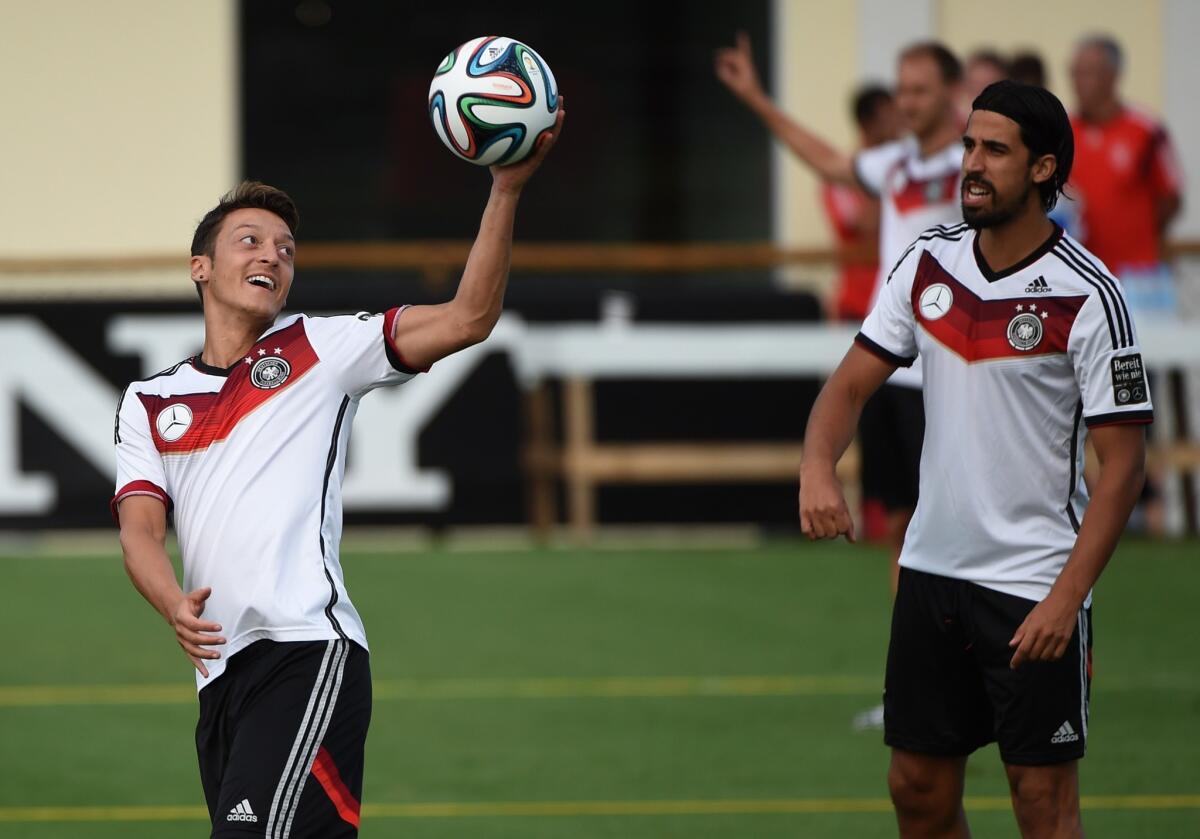 Germany's Mesut Ozil, left, and Sami Khedira warm up during a training session in Santo Andre on Thursday.