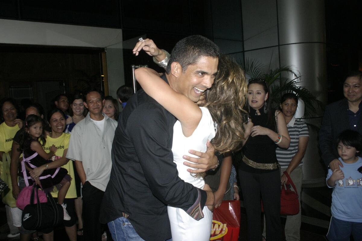 David Bunevacz hugs his wife, Jessica Rodriguez, at a 2007  event in the Philippines.