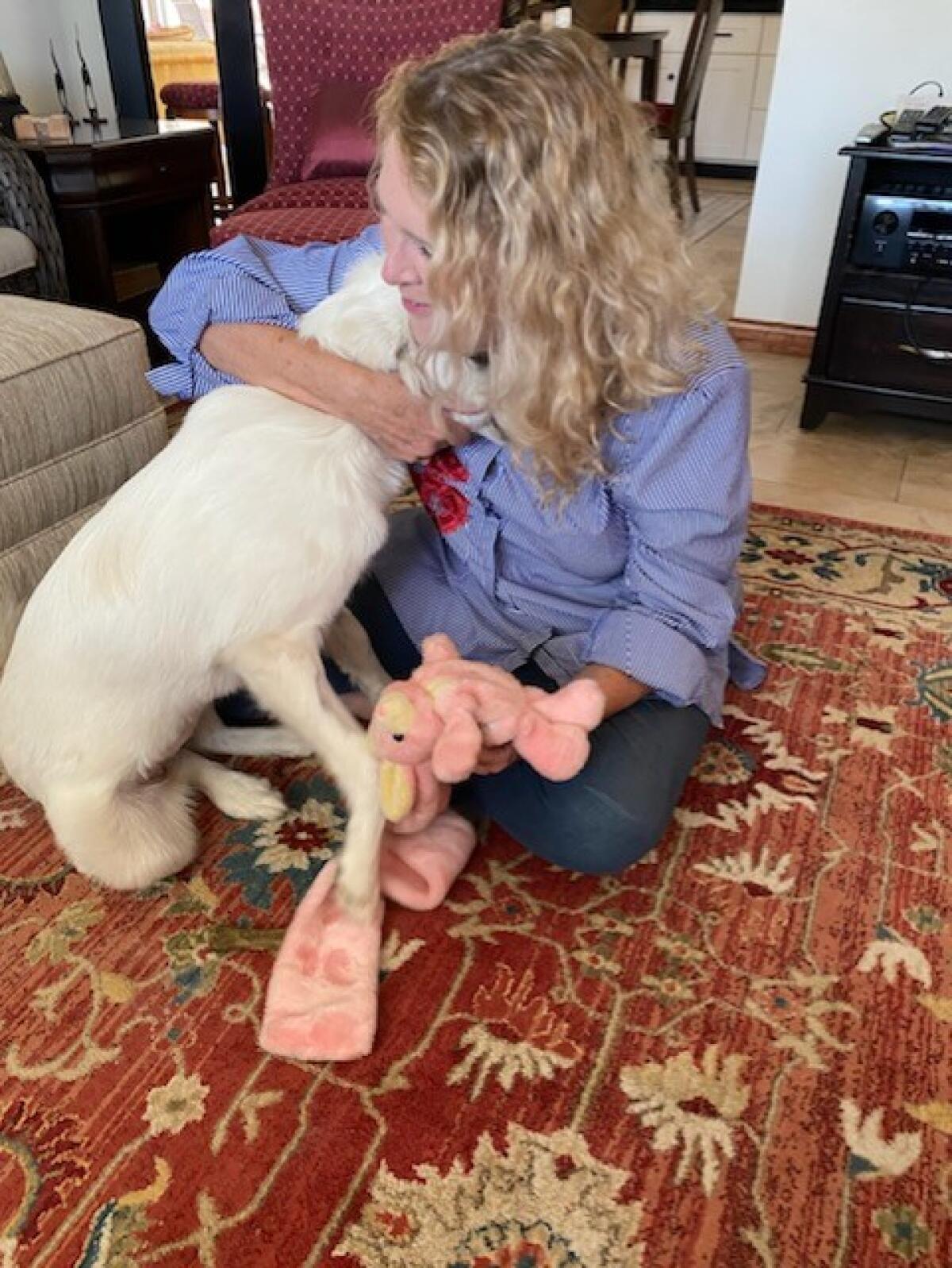 Reidel Post, 64, hugs her dog Katie.