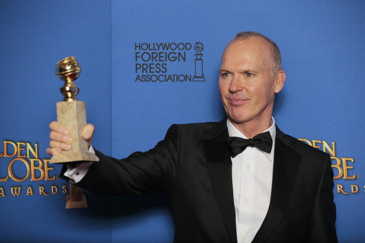 Michael Keaton holds his award for lead actor in a musical or comedy motion picture in the press room at the 72nd Golden Globe Awards.