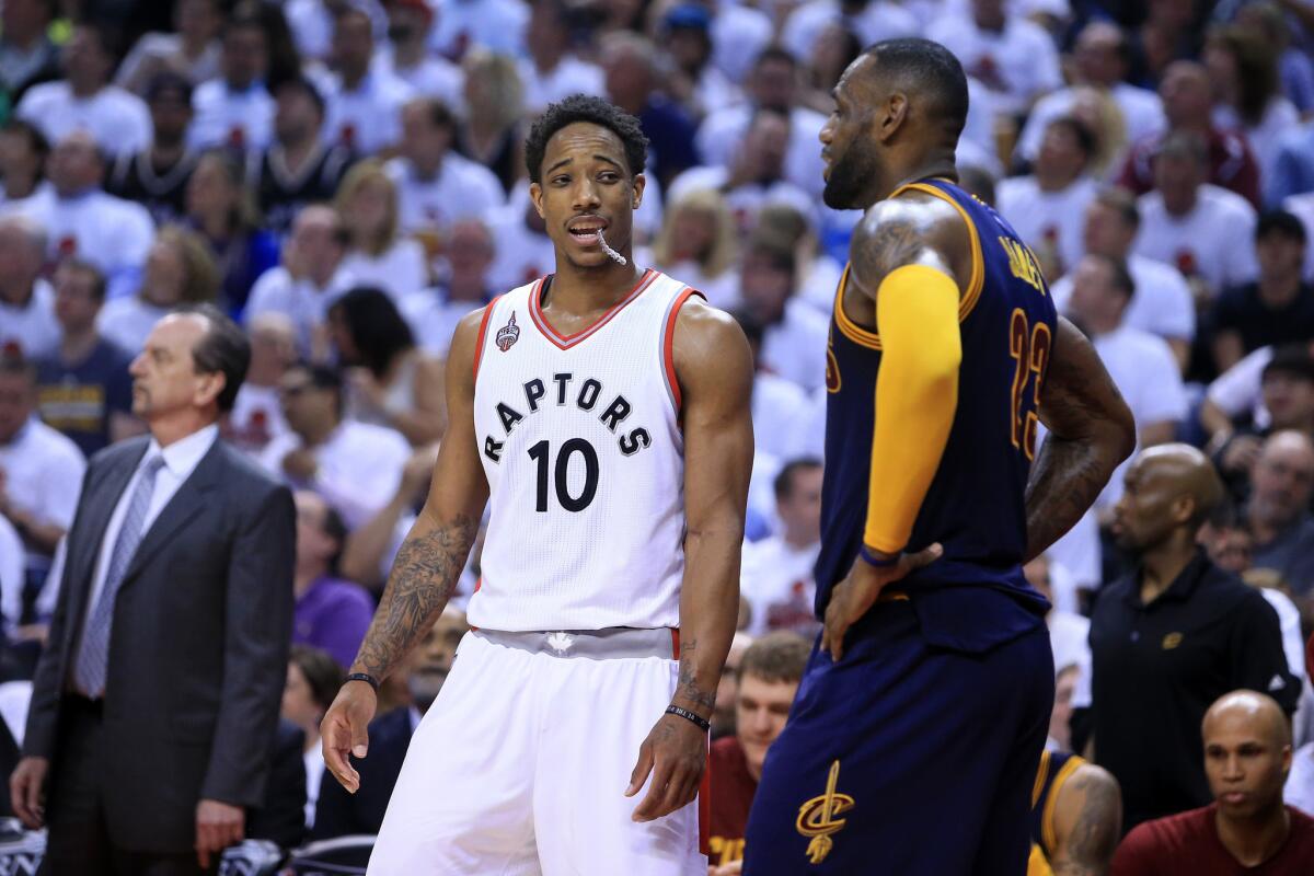 Raptors forward DeMar DeRozan chats with Cavaliers star LeBron Jamesin the third quarter of Game 4.