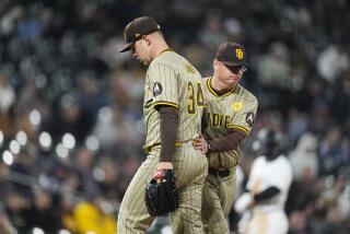 San Diego Padres starting pitcher Michael King, front, is pulled form the mound by San Diego Padres manager Mike Shildt in the fourth inning of a baseball game against the Colorado Rockies Tuesday, April 23, 2024, in Denver. (AP Photo/David Zalubowski)