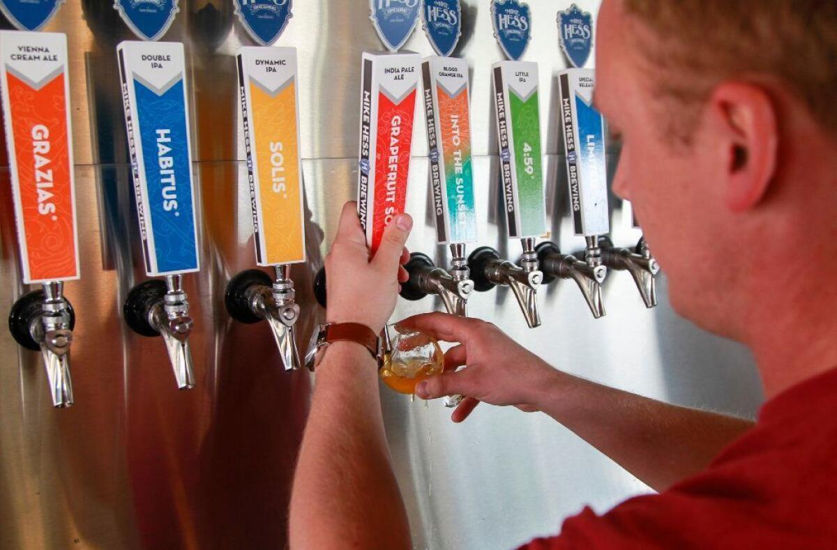 Beer tender Zack Ingram pours a beer at Mike Hess Brewing in Imperial Beach.