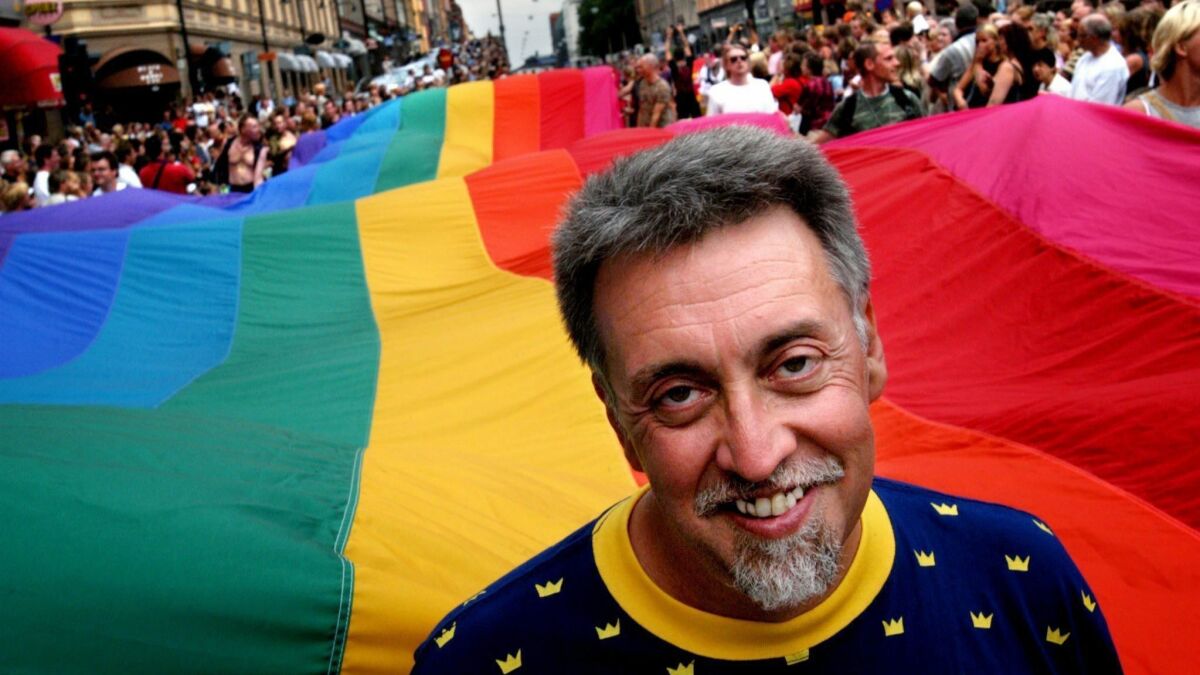 Artist and activist Gilbert Baker heads the Stockholm Pride Parade carrying a 250-meter flag in Sweden in August 2003.