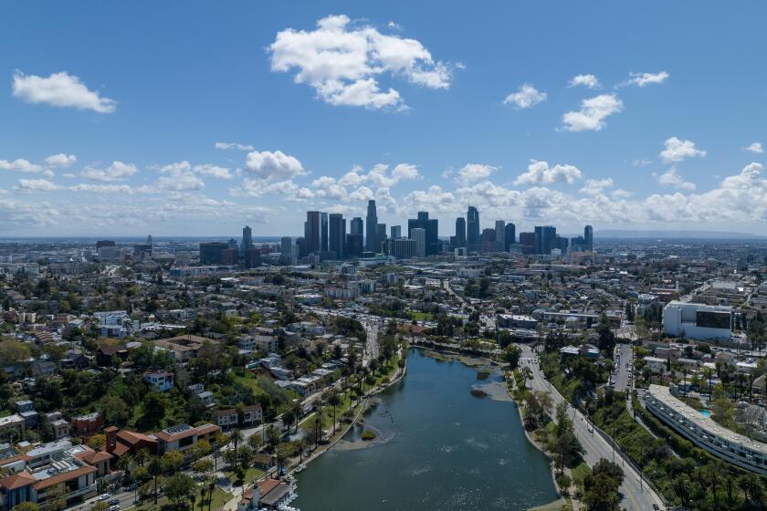 Los Angeles, CA - March 29: Storm clouds move out of the Los Angeles Basin in a view over Echo Park Lake toward downtown on Wednesday, March 29, 2023 in Los Angeles, CA. (Brian van der Brug / Los Angeles Times)