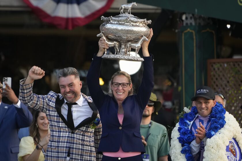Trainer Jena Antonucci, center, hoists up the August Belmont Trophy alongside jockey Javier Castellano, right, and owner Jon Ebbert, left, after their horse Arcangelo won the 155th running of the Belmont Stakes horse race, Saturday, June 10, 2023, at Belmont Park in Elmont, N.Y. (AP Photo/Seth Wenig)