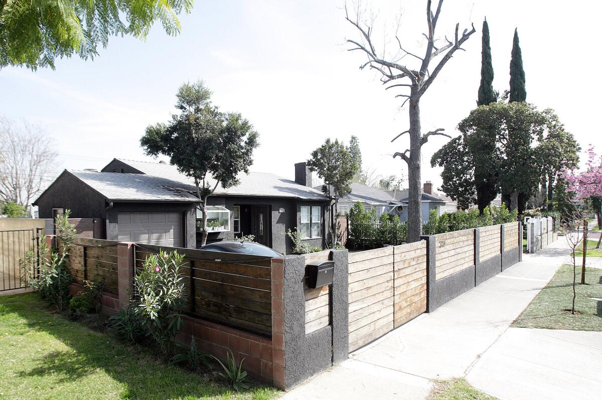 The home and fence on the 2300 block of North Naomi Street in Burbank on Friday, Feb. 26, 2016. The city of Burbank had to step in to end a two-year argument between neighbors about the fence.