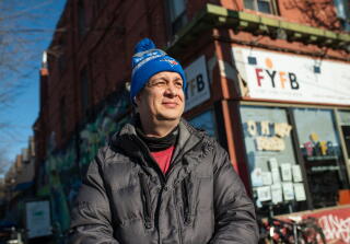 A man stands outside a food bank