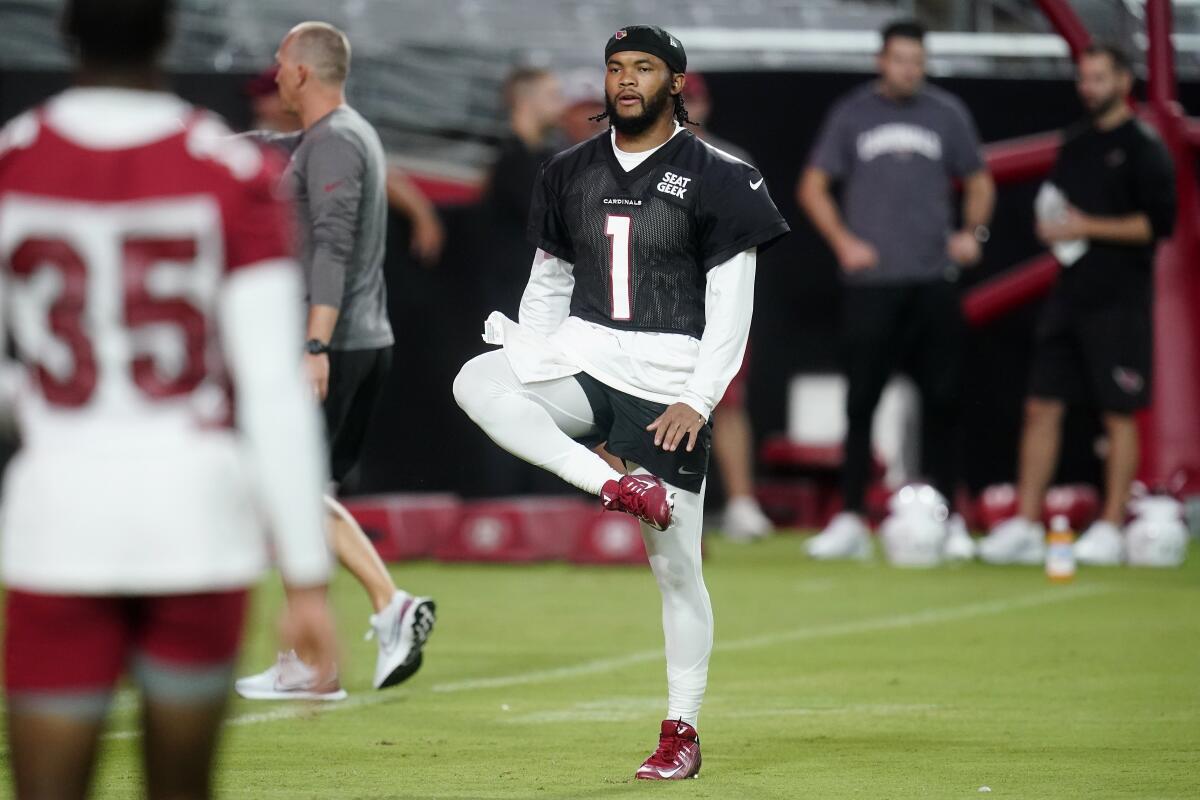 Arizona Cardinals quarterback Kyler Murray stretches with other teammates, including cornerback Christian Matthew (35), before taking part in drills in the NFL football team's training camp at State Farm Stadium, Thursday, July 28, 2022, in Glendale, Ariz. (AP Photo/Ross D. Franklin)