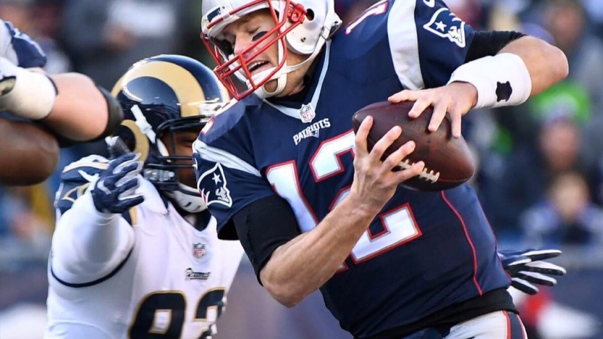 Rams defensive lineman Ethan Westbrooks applies pressure to Patriots quarterback Tom Brady in the second quarter on Dec. 4, 2016.