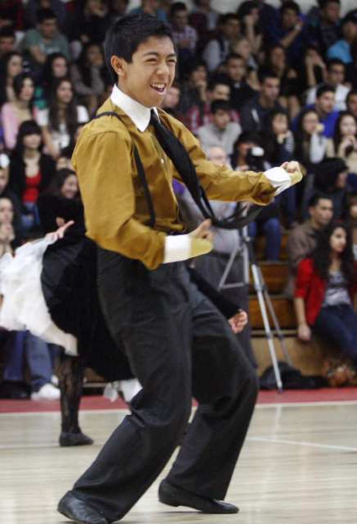 Glendale's Jason Te performs during their spirit assembly, which took place at Glendale High School on Friday. The Varsity Girls and Junior Varsity Girls won first place awards for both large and small dance routines, for four first-place titles, followed by first place co-ed team performance that got the dance team to the 12th National Title.