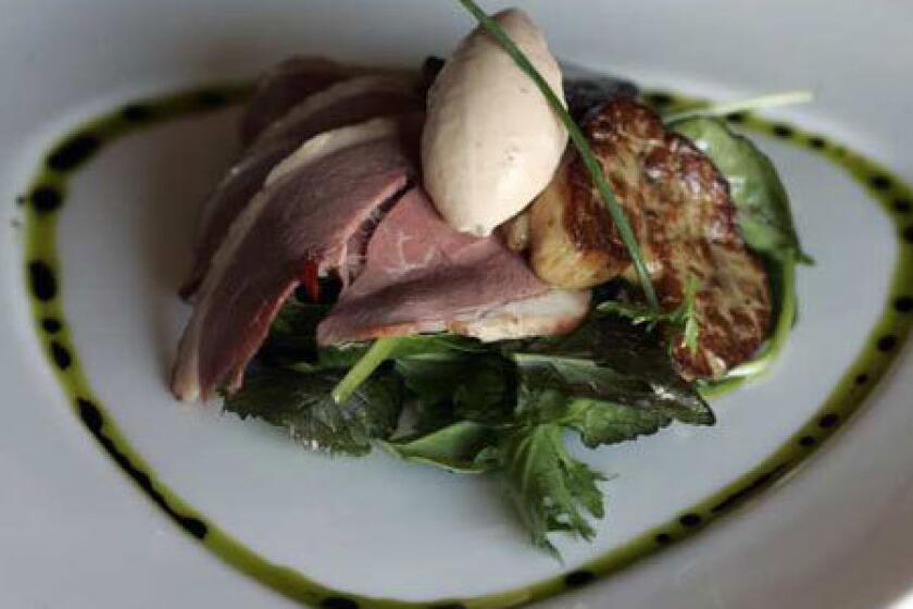 A trio of duck, smoked duck breast and grilled foie gras on a salad with lemon-marinated red cabbage, cucumber and radicchio at Maximilians Austro-Hungarian Restaurant in North Hollywood.