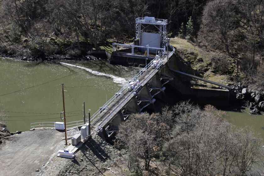 FILE - In this March 3, 2020, file photo, a dam on the Lower Klamath River known as Copco 2 is seen near Hornbrook, Calif. A new agreement announced Tuesday, Nov. 17, 2020, promises to revive faltering plans to demolish four massive hydroelectric dams on a river along the Oregon-California border to save imperiled salmon by emptying giant reservoirs and reopening hundreds of miles of potential fish habitat that's been blocked for more than a century. (AP Photo/Gillian Flaccus, File)