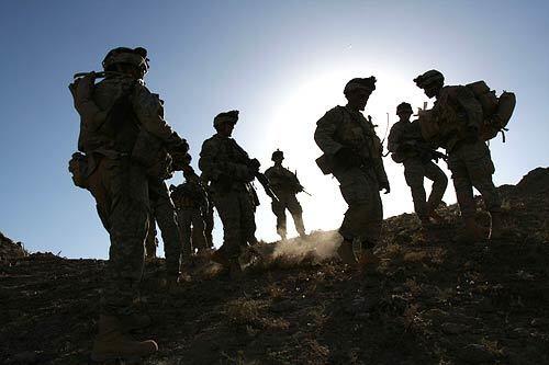 U.S. soldiers from the 2nd Battalion, 87th Infantry Regiment, 10th Mountain Division, prepare to make a patrol near a fortified position in a mountain at Helmand Province, southern Afghanistan.